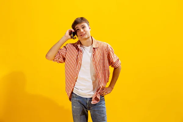 Portrait Young Man Checkered Shirt Posing Cheerfully Talking Phone Isolated — 图库照片