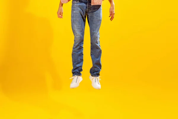 Cropped Image Male Legs Jeans White Sneakers Isolated Yellow Studio — Zdjęcie stockowe