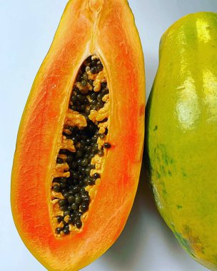 Olgun papaya, yarım papaya ve bir bütün, olgun papaya tohumları, sulu portakal meyvesi, doğal vitaminler.