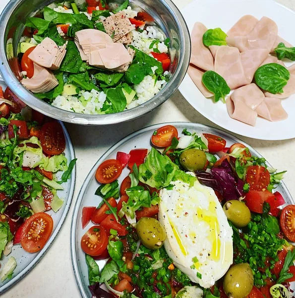 plates with vegetables, cold cuts, colourful plates with vegetables and cheese on them, vegan cold cuts, tomatoes, mozzarella, green olives, chopped green onions, plates with appetisers