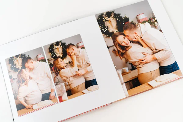 page photobook from photo shoot of couple during pregnancy in new years kitchen