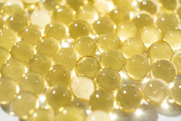 Kapsul gelatine kuning lembut. close-up. Produksi farmasi. — Stok Foto