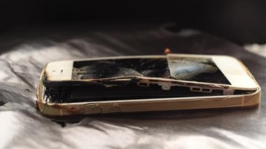 Siyah arkaplanda bozuk akıllı telefon yakmak. 