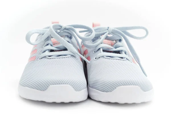 Gray sports sneakers with pink stripes on a white background. adidas — Stock Photo, Image