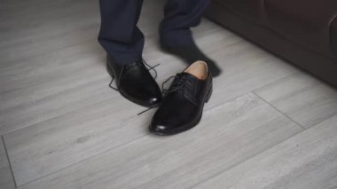 Bir erkek siyah ayakkabıları bağcıkla bağlar. Erkek modası. iş biçimi.