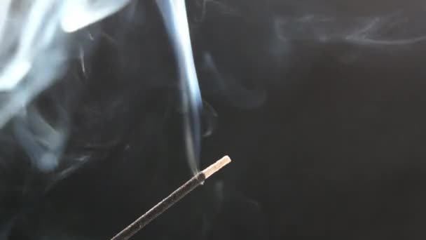 Smoke from an aromatic stick on a black background. — Stock Video