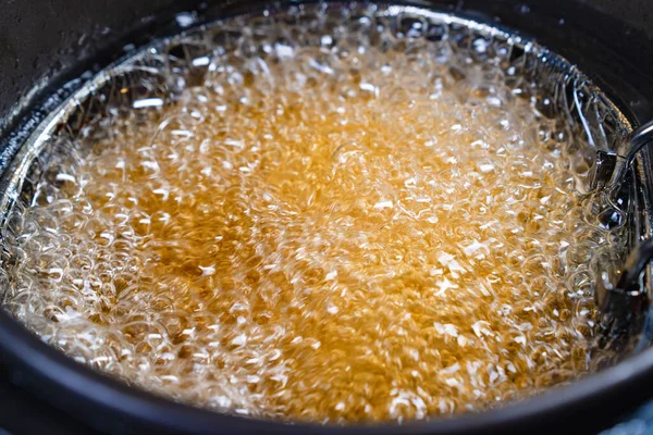 Top view. oil boiling in deep fryer. in fryer cook shrimp in batter or potatoes. — Stock Photo, Image