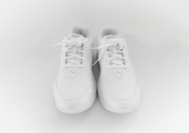 Beyaz arka planda bağcıkları olan beyaz spor ayakkabılar. İzole et. puma