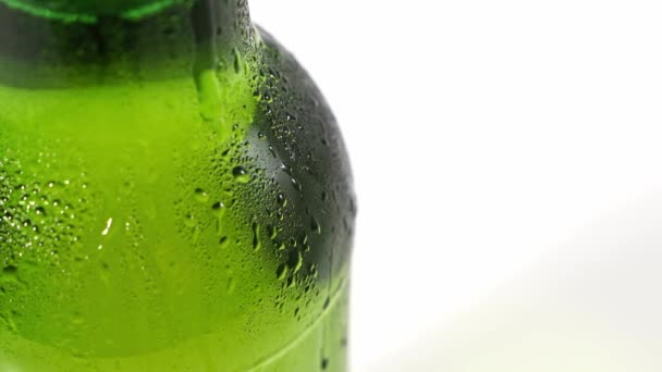 Close up. drops flow down the cold green glass of the bottle. condensate — Stock Video