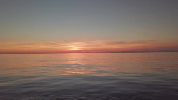 Střílení při západu slunce na moři. večerní obloha nad vodou. — Stock video
