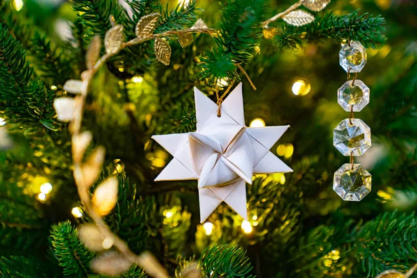 Een zilveren ster op een sparren tak. traditionele kerstversiering. — Stockfoto