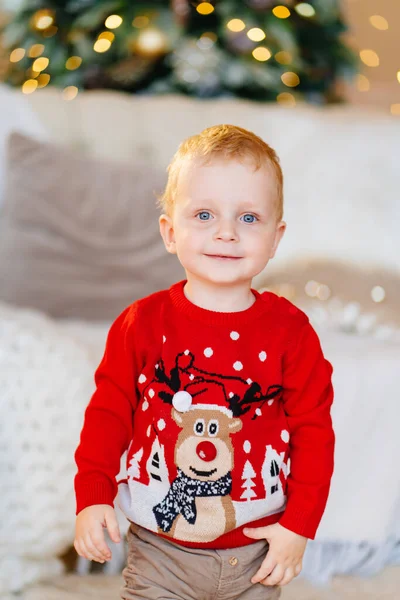 Menino bonito em uma camisola de Natal vermelho. roupas e presentes tradicionais — Fotografia de Stock