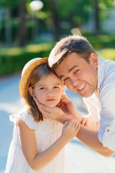  Baba kızlarını nazikçe ve sevgiyle elleriyle tutuyor.. 