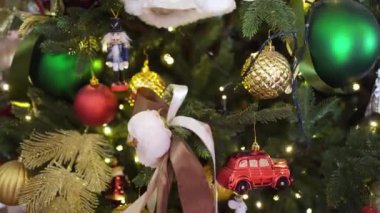 part of the Christmas tree with different toys and an electric garland.