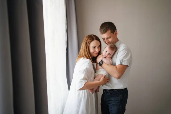 a happy family with a newborn baby. mom, dad and baby.