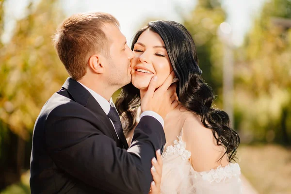 Brudgummen kramar försiktigt bruden. Glada nygifta. romantiska relationer. — Stockfoto