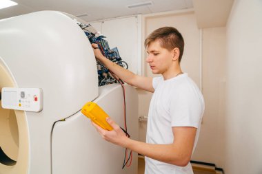 Mühendis elektrik cihazındaki voltajı ölçer..