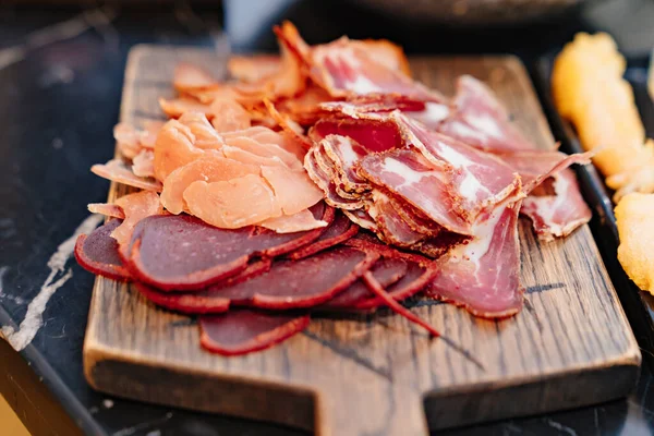 Meat cuts on a wooden cutting board. dried delicacy meat. — Stock Photo, Image