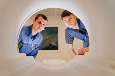 MRI cihazlarının kurucu mühendisleri tarayıcıda. mavi üniforma