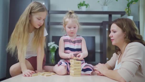 Mom and daughters play blocks. educational and interesting games for family. — Stock Video