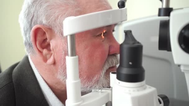 Examen de anciano con lámpara de hendidura. equipar la oficina de oftalmólogos. — Vídeos de Stock