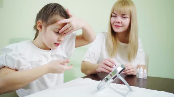 Médico enseña a la niña a ponerse lentes de contacto en clinic.orthokeratological lentes — Vídeo de stock