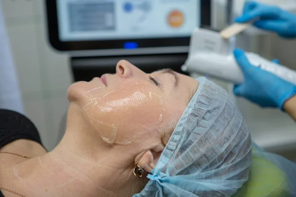 Non-surgical face lifting. SMAS lifting ultrasonic. The process of rejuvenation. Hardware cosmetology. contour face plastic. Dermatologist doctor make a Caucasian woman an ultrasound facelift