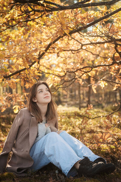 Young teenager girl in the autumn forest. Autumn colors . Lifestyle. Autumn mood. Forest
