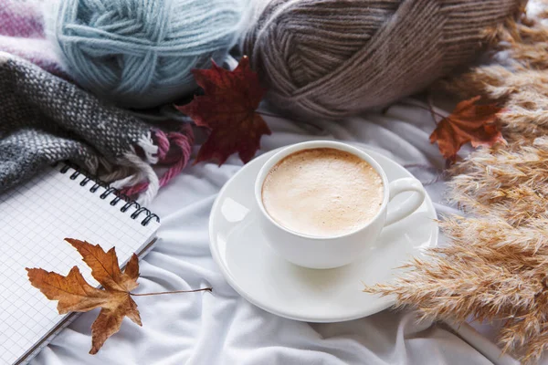 Autumn still life with  pumpkins, coffee and burning candles. Cozy fall composition