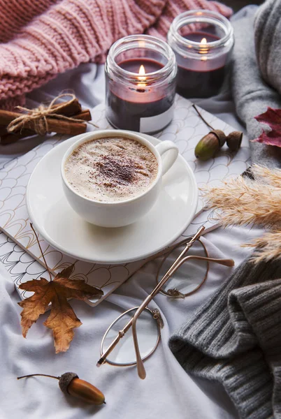 Autumn still life with  pumpkins, coffee and burning candles. Cozy fall composition