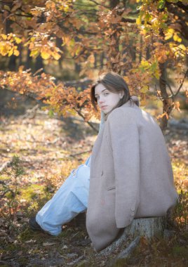 Düşünceli ve üzgün bir kızın portresi. Sonbahar renkleri. Yaşam tarzı. Sonbahar havası. Orman