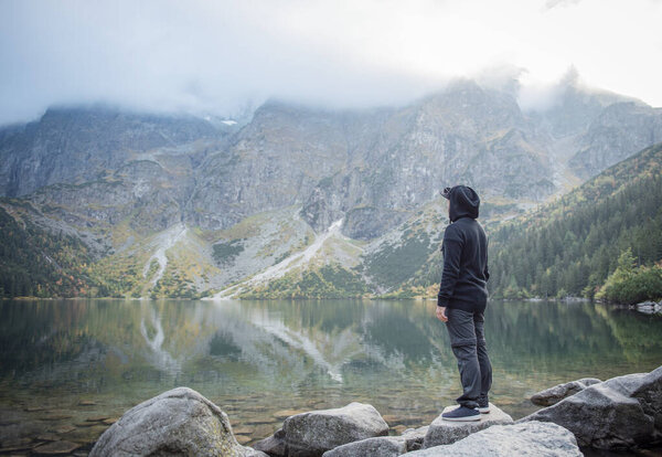 Hiking man travel outdoor lifestyle.  Young traveler hiker at mountains landscape