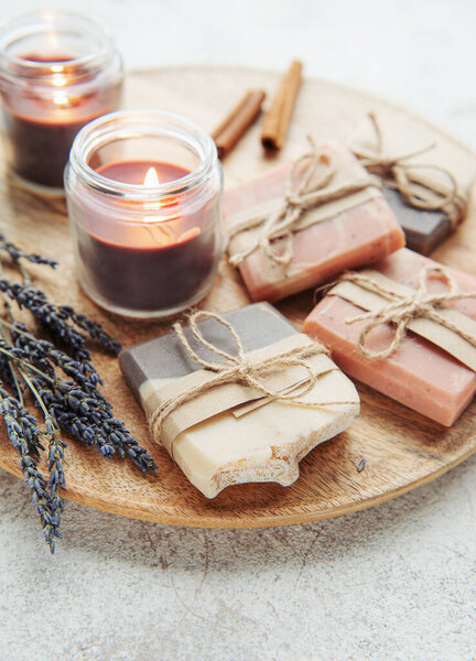 Concept of spa with natural organic handmade soap. Moisturizing skin care and aromatherapy. Gentle body treatment. Handmade soap. Atmosphere of harmony, relax. flowers, candle