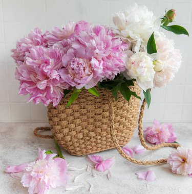 Şakayık çiçekli hasır çanta, yaz çiçeği konsepti..