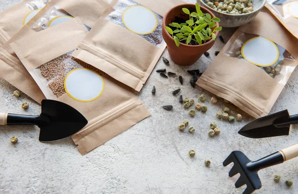 Microgreen seeds in paper bags and microgreen sowing equipment on the table. Healthy food.