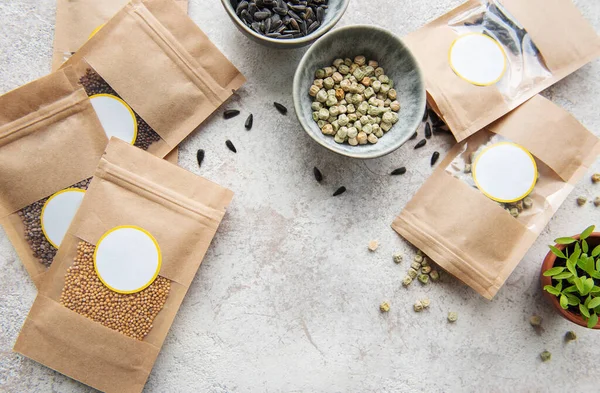 Microgreen seeds in paper bags and microgreen sowing equipment on the table. Healthy food.