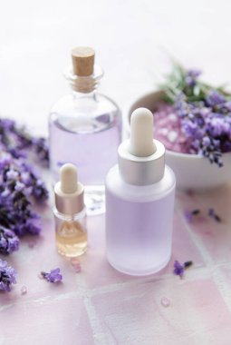 Spa products and lavender flowers.  Aromatherapy lavender bath salt and massage oil