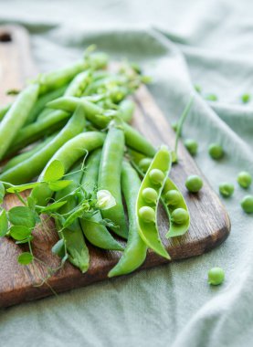 Young fresh juicy pods of green peas. Healthy organic food. 
