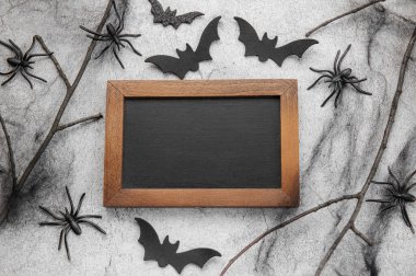 Halloween holiday background with  decorations.  Halloween background with spider web and spiders as symbols of Halloween. View from above. Flat lay