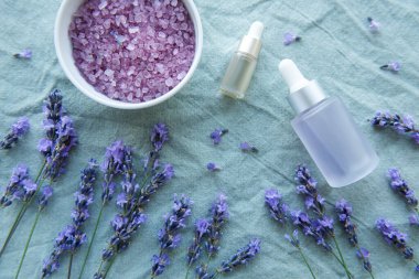 Spa products and lavender flowers.  Aromatherapy lavender bath salt and massage oil