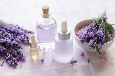 Spa products and lavender flowers.  Aromatherapy lavender bath salt and massage oil