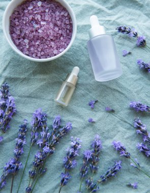 Spa products and lavender flowers.  Aromatherapy lavender bath salt and massage oil