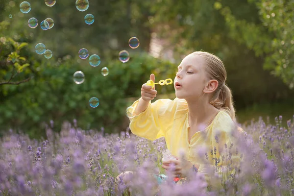 Beautiful Little Girl Catches Soap Bubbles Field Lavender —  Fotos de Stock