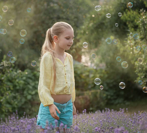 Beautiful Little Girl Catches Soap Bubbles Field Lavender — Stockfoto
