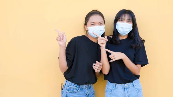 Portrait Two Young Girl Wear Mask Standing Together Orange Backgroynd — Stock Photo, Image
