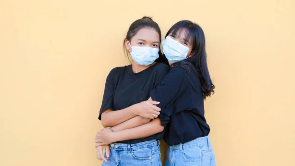 Portrait Two Young Girl Wear Mask Standing Together Orange Backgroynd — Stock Photo, Image