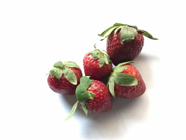 five strawberries isolated on white background . Strawberry isolated. Strawberries with leaf isolate. Whole and half of strawberry on white. Strawberries isolate. Side view strawberries set.