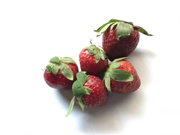 five strawberries isolated on white background . Strawberry isolated. Strawberries with leaf isolate. Whole and half of strawberry on white. Strawberries isolate. Side view strawberries set.