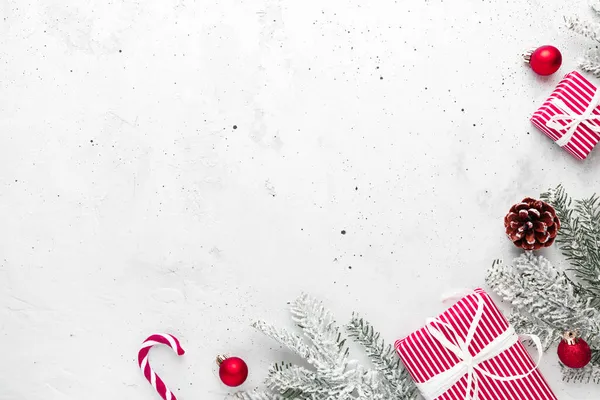クリスマス 新年の灰色のコンクリートフラット赤白プレゼントギフトボックストップビューとレイアウト ギフトリボンと包装紙 クリスマスツリーモミ コーン おもちゃ キャンディースティックロリー コピースペーステキストエリア — ストック写真