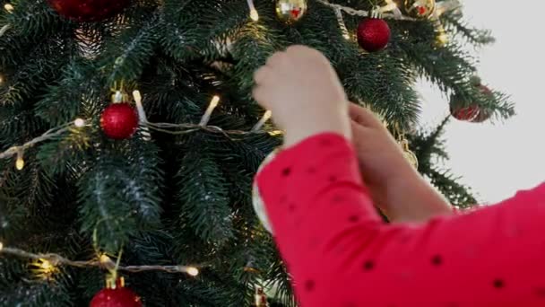 Child Hands Decorate Christmas New Year Fir Tree Sphere Toys — Stock Video